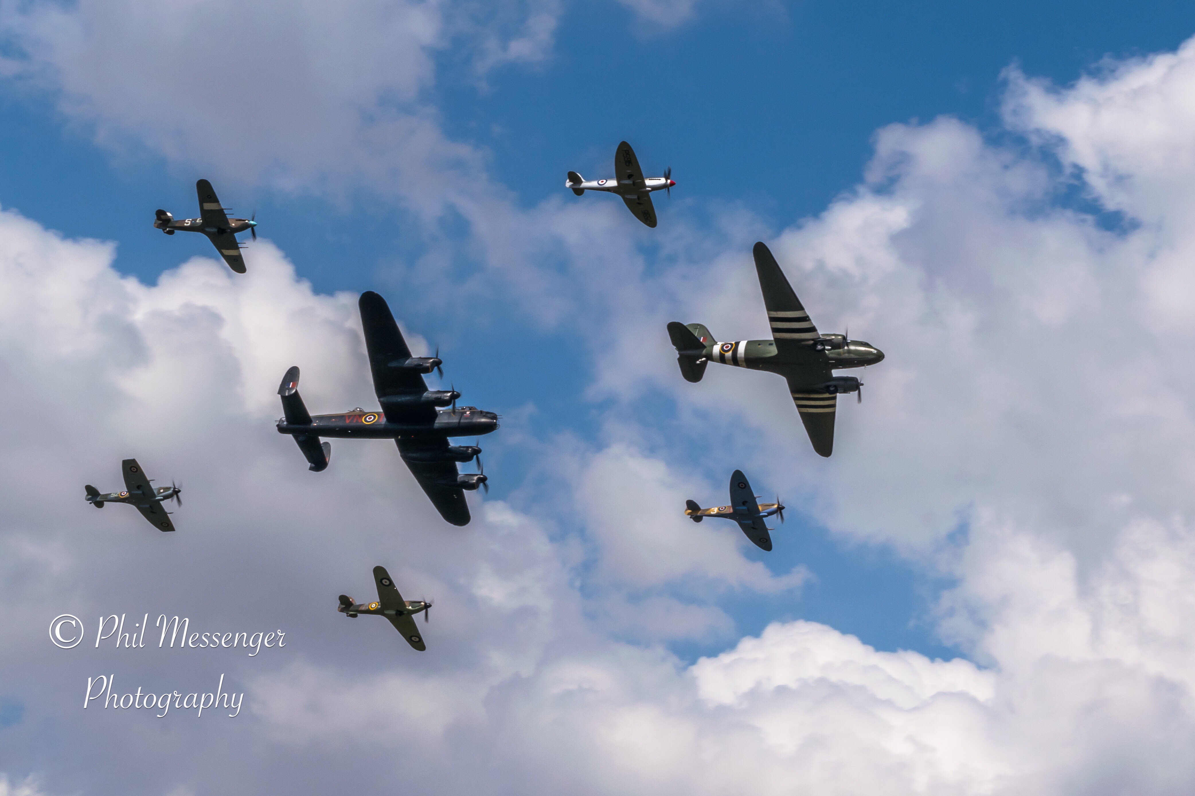 BBMF C-47 Dakota, Avro Lancaster, Spitfires and Hurricanes flying in Trenchard formation at the Royal International Air Tattoo, Fairford, England.