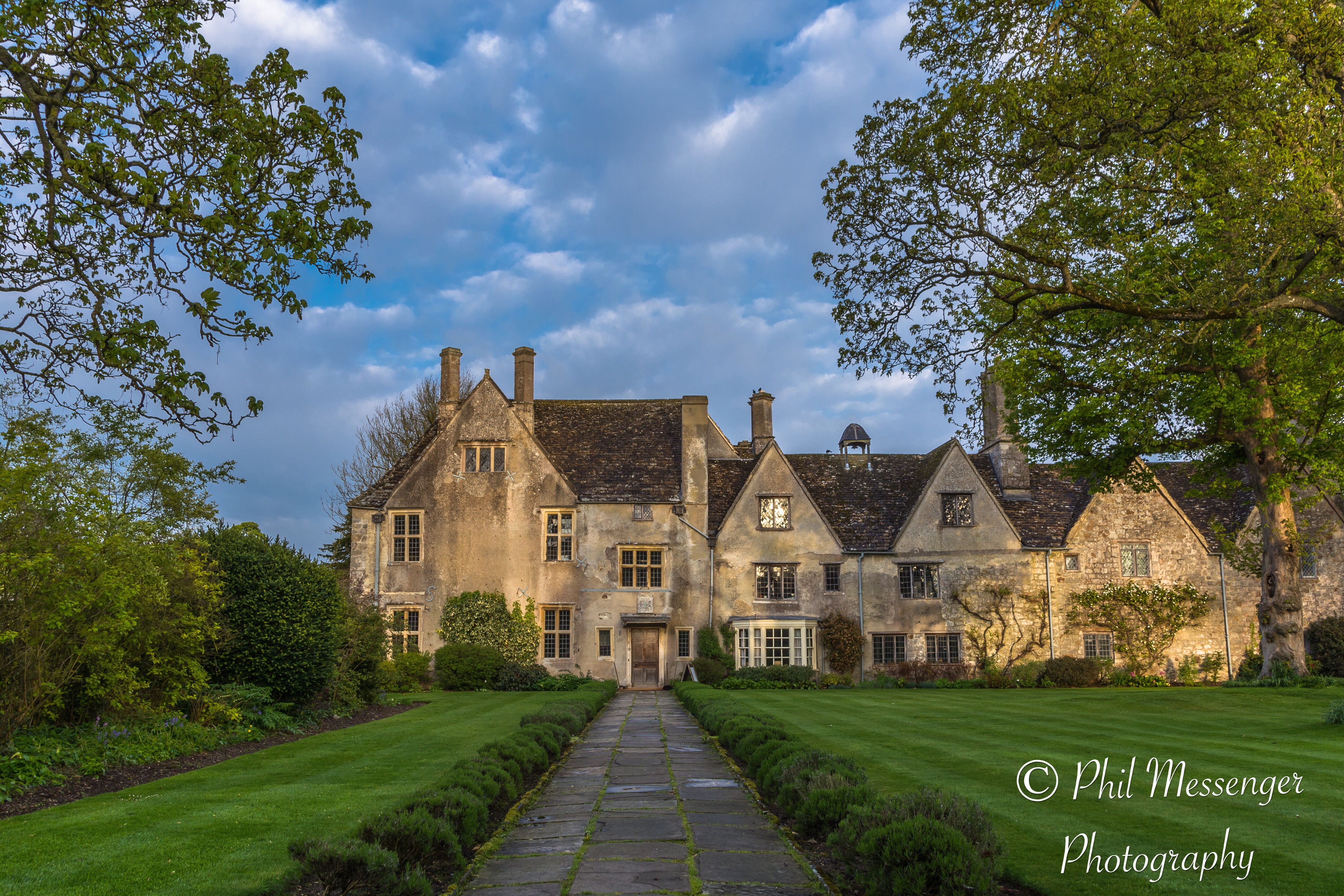 Avebury manor veiled in early morning spring sunshine. Avebury, Wiltshire, England.