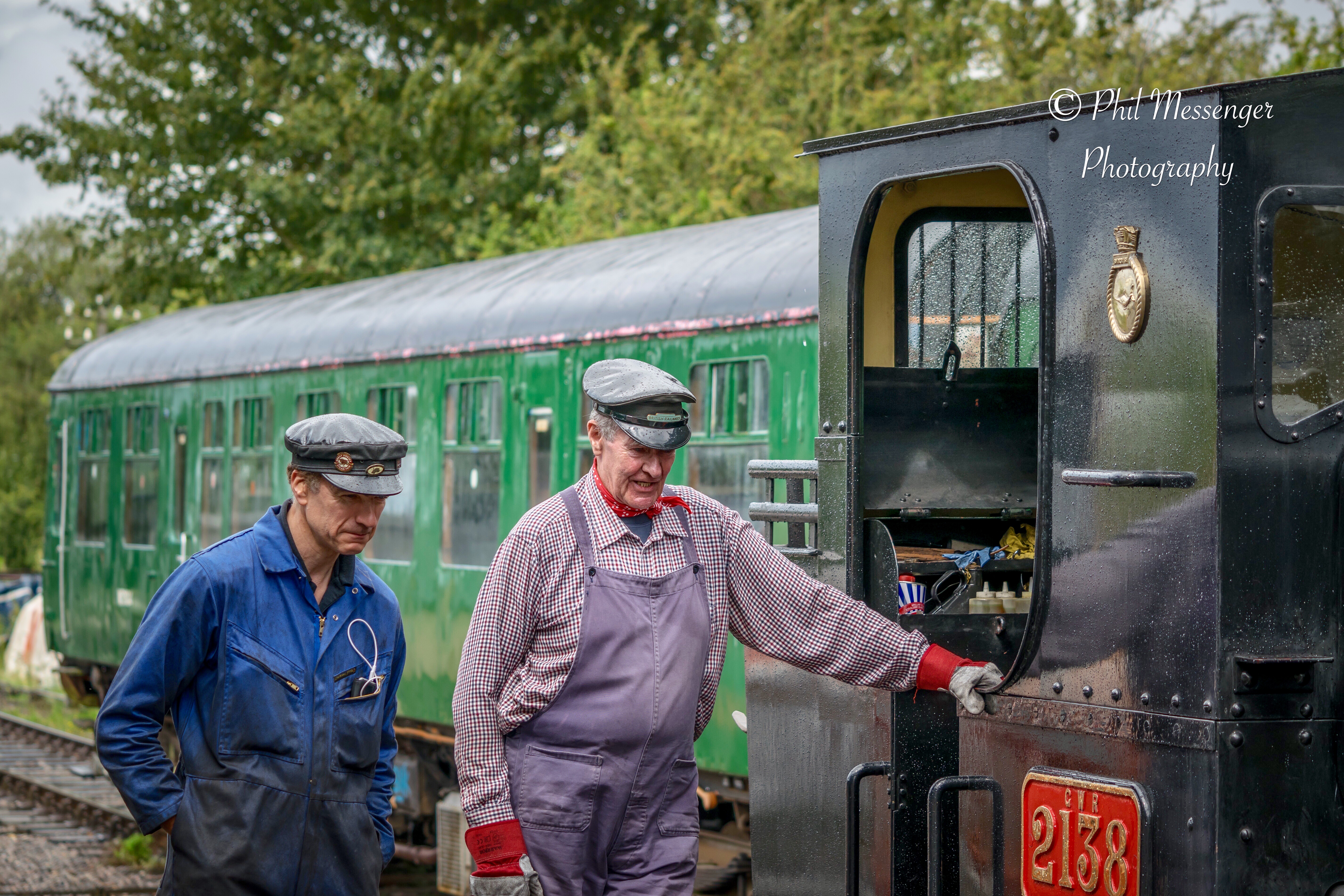 Volunteers at Swindon and  Cricklade railway steam train having a water refill at Blunsdon Station