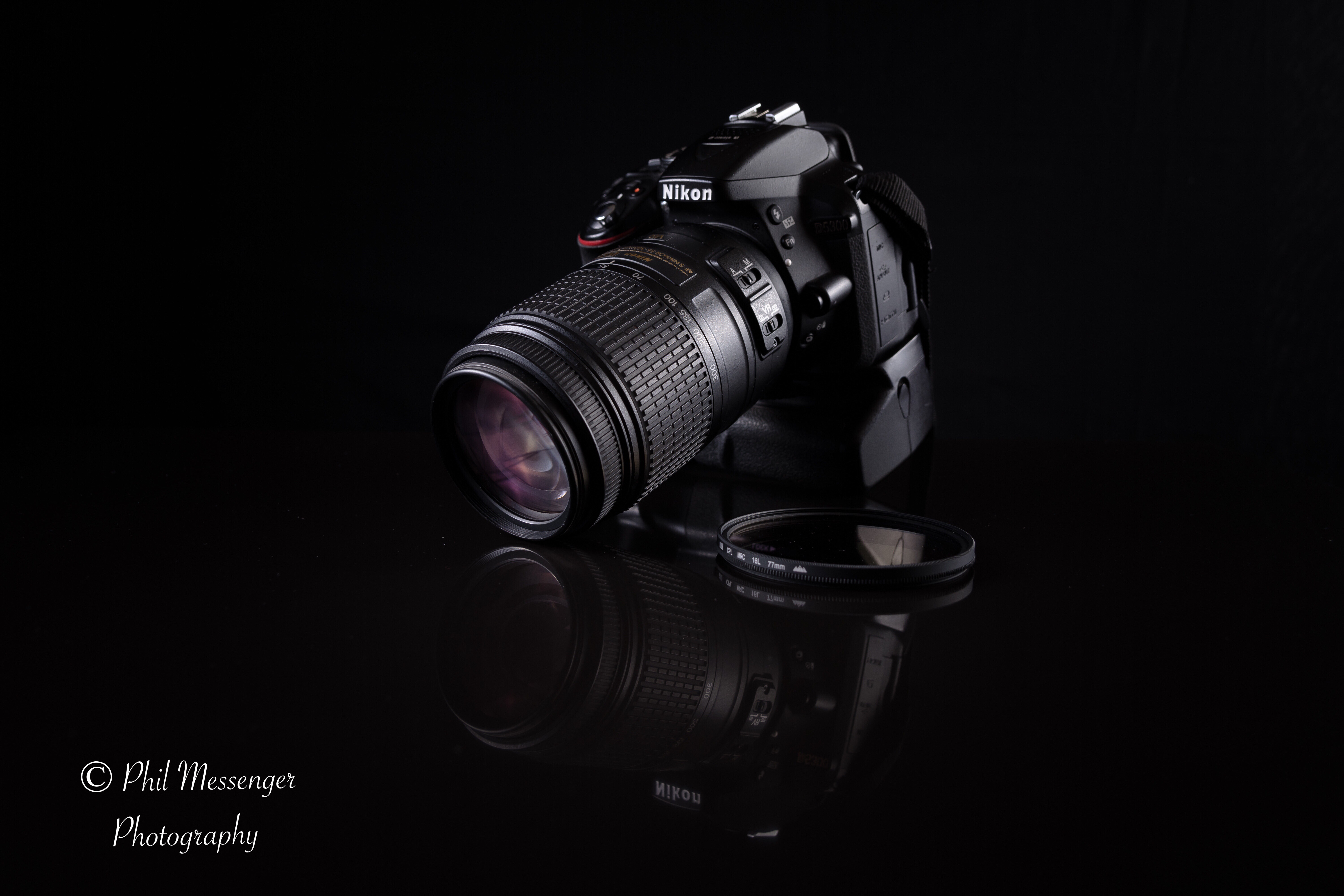 Photographing my Nikon D5300 with my Nikon D5200 on a black background.