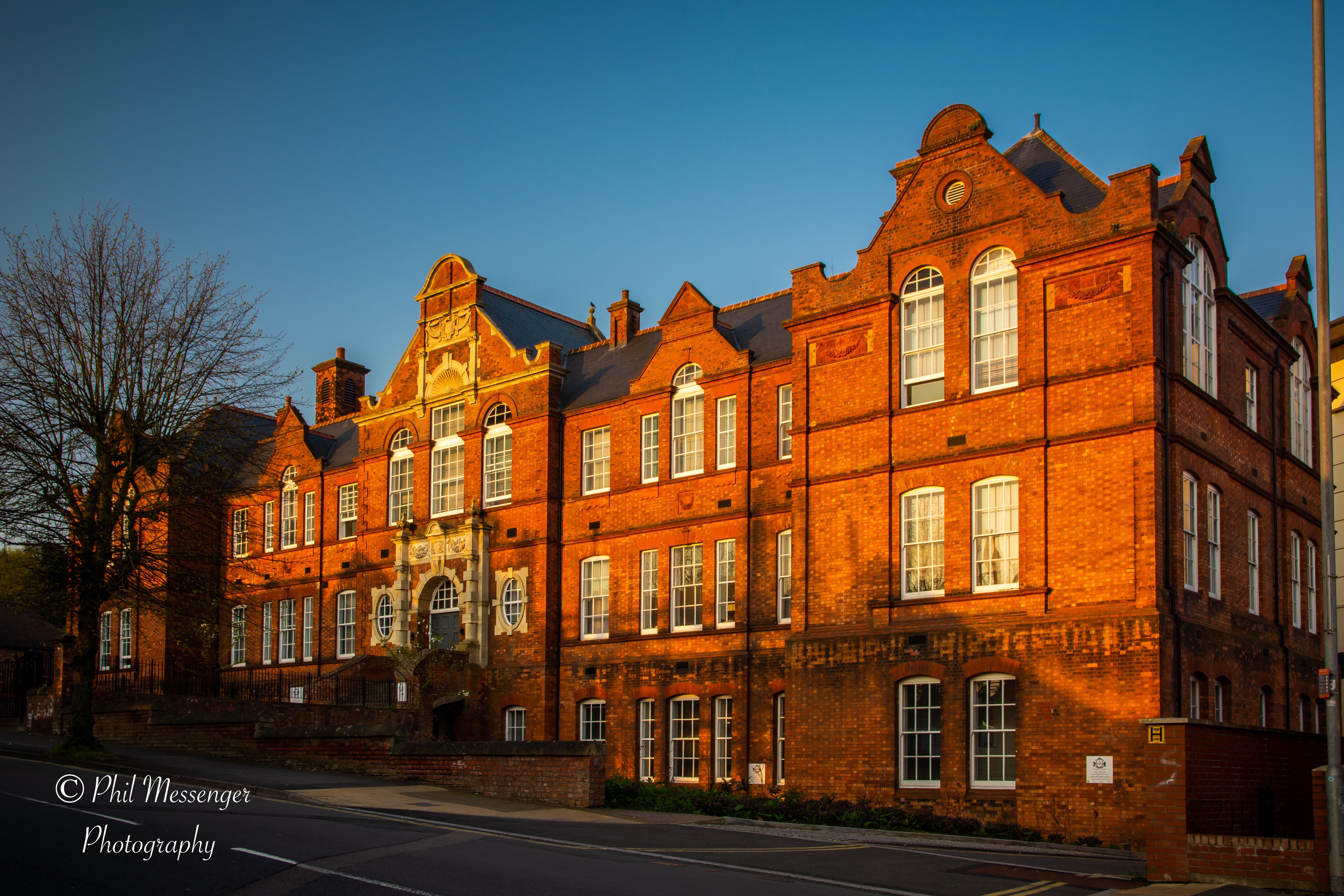 Victorian nineteenth century Technical College building, Victoria Road, Swindon veiled in early morning sunshine.