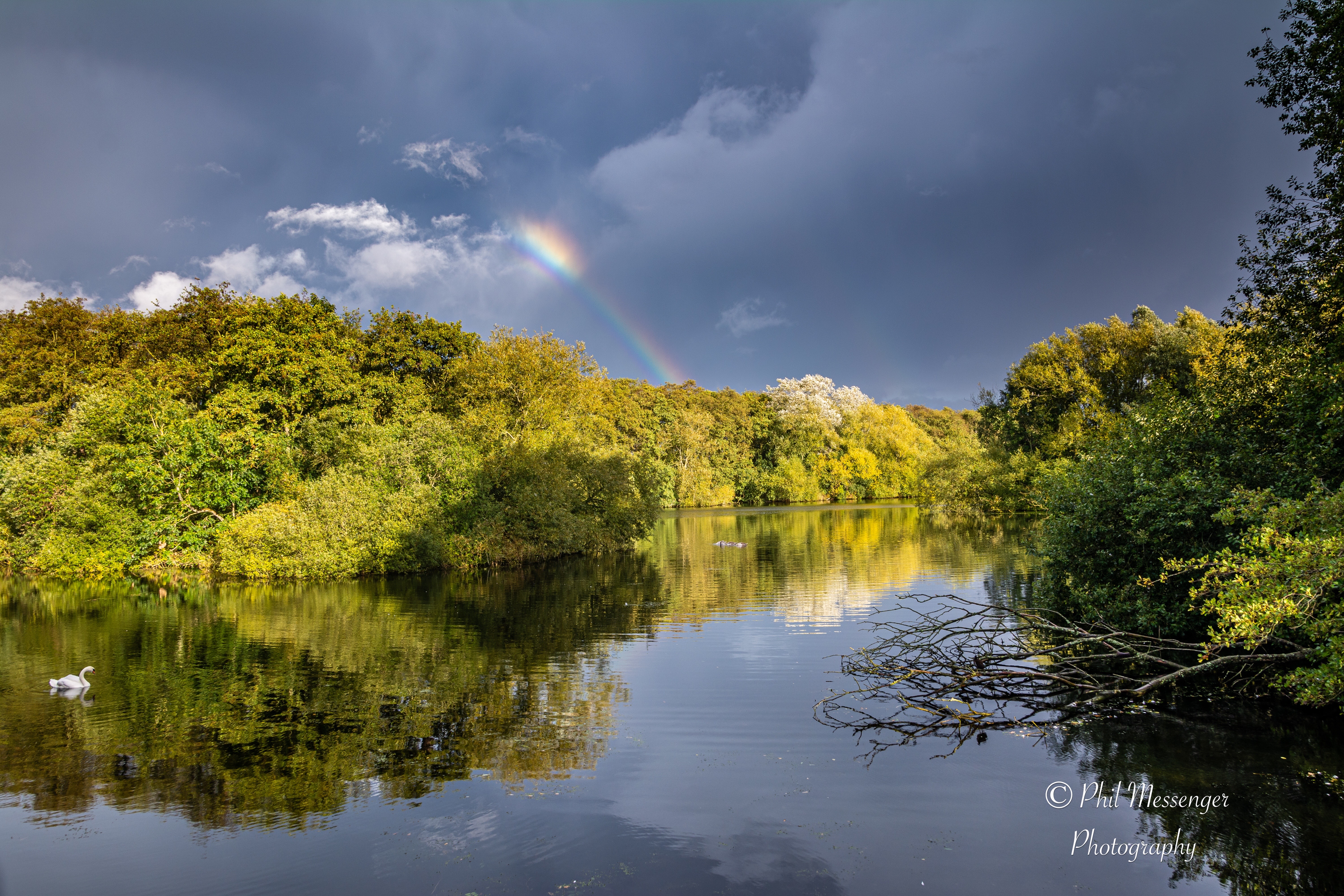 Another very small rainbow against dark clouds at Coate Water Swindon from yesterday afternoon after the rain.